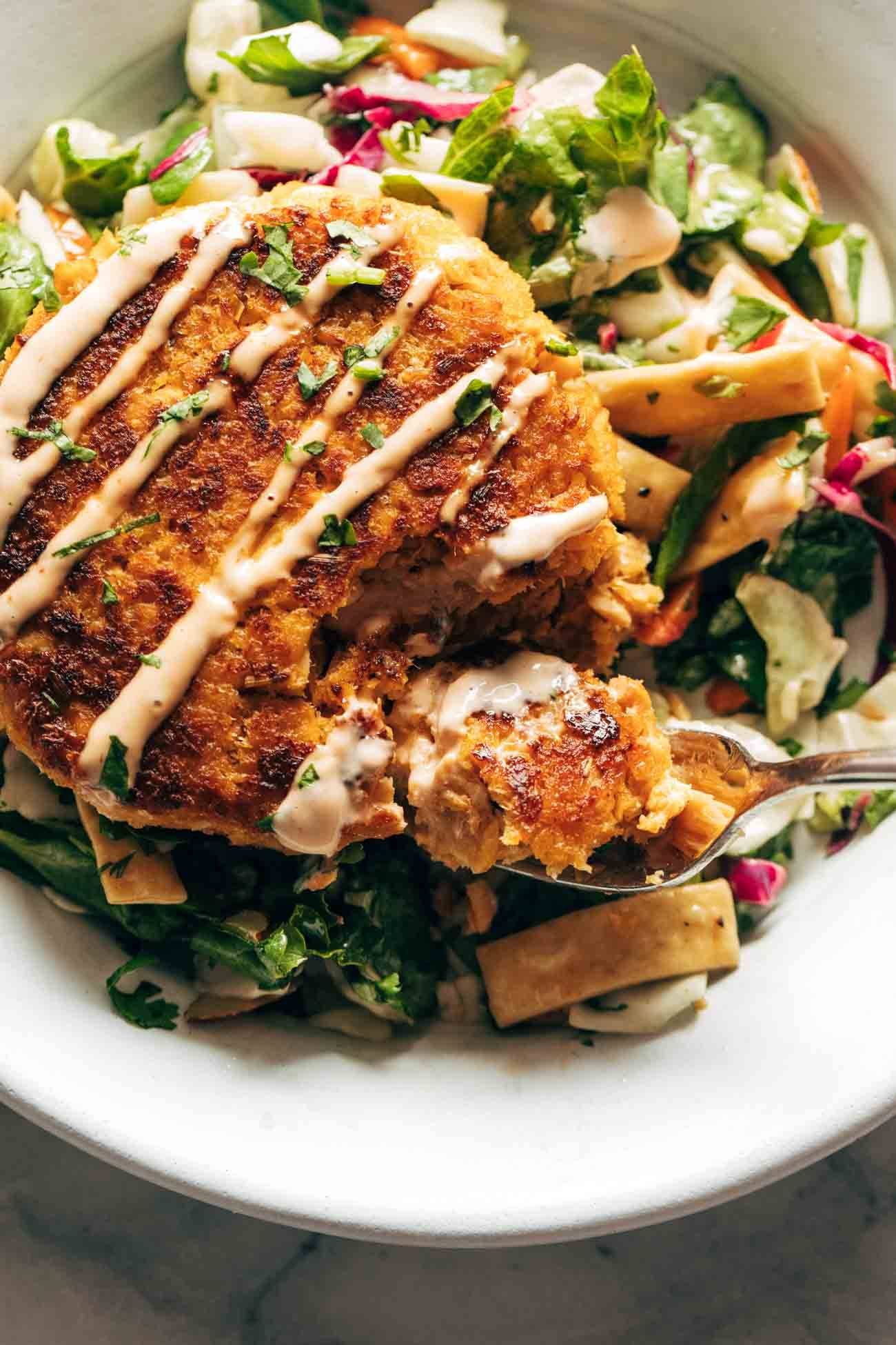Spicy salmon burger with salad.